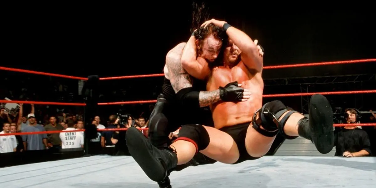 A wrestler delivers a stone cold stunner in the ring